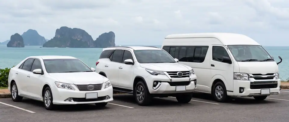 Sedan, SUV and van parked above the sea